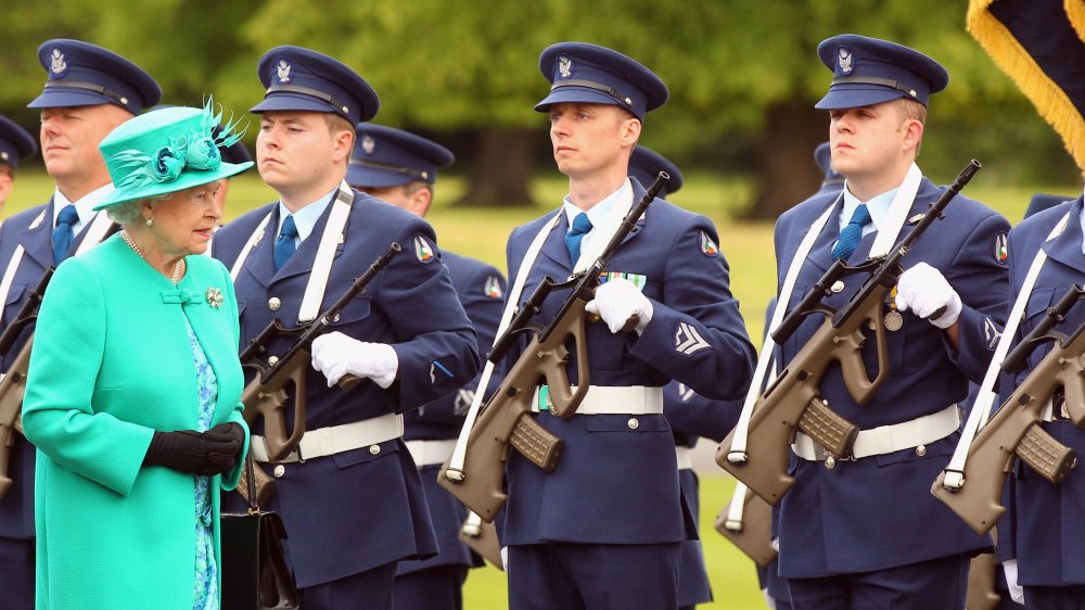 Queen Elizabeth and armed security guards