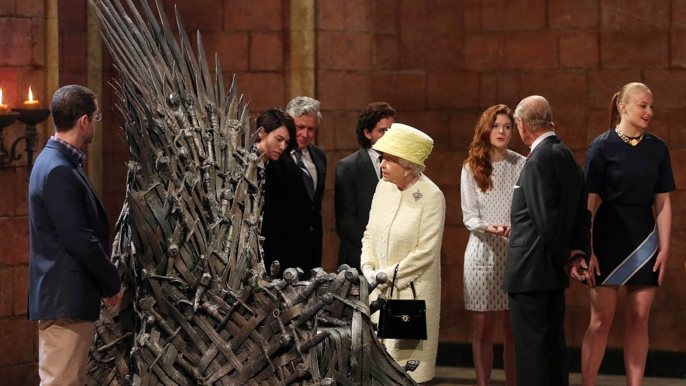 Queen Elizabeth  looking at the iron throne from Game of Thrones