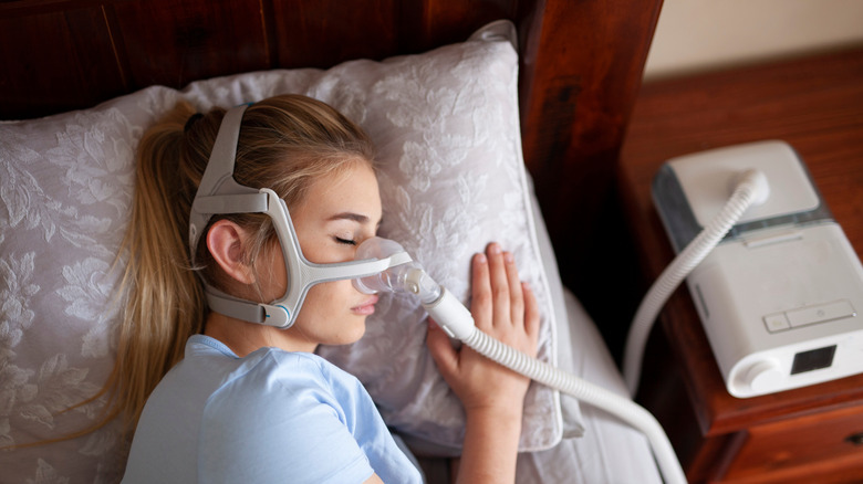 Woman with sleep apnea machine