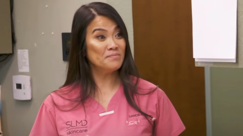 Dr. Pimple Popper in pink scrubs