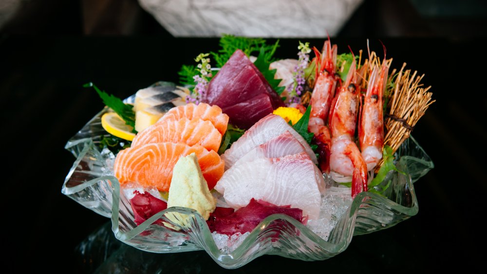 Sashimi in a bowl with garnishes