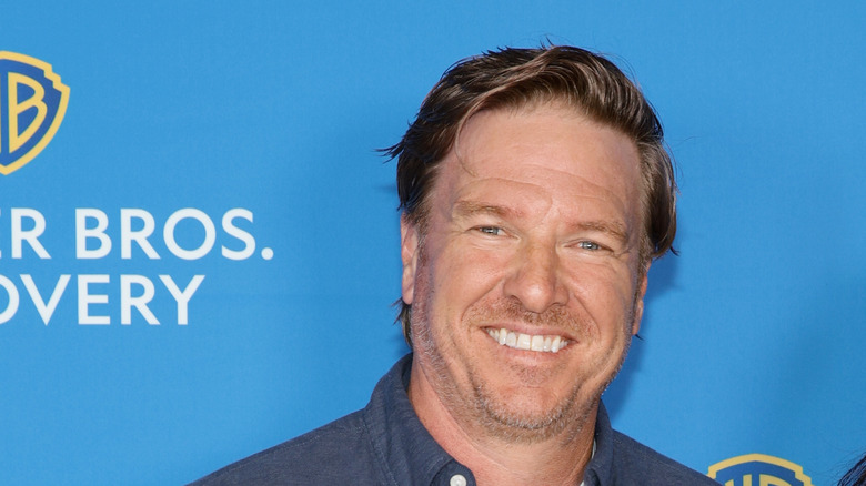 Chip Gaines smiling blue background