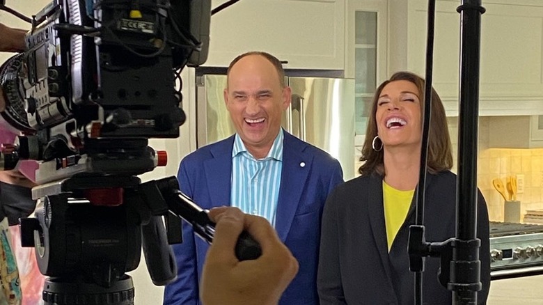 Hilary Farr and David Visentin laugh behind the scenes 