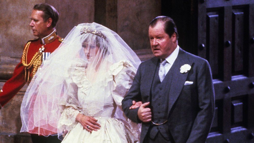 Princess Diana walking down the aisle with her father at her wedding