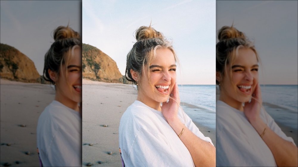 TikTok star Addison Rae on the beach, winking