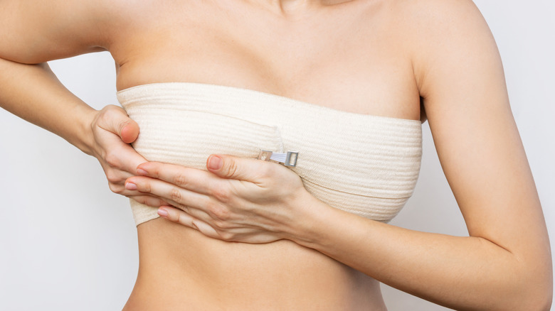 woman with bandages after breast surgery