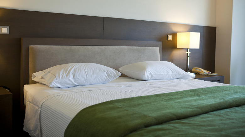 bedside lamp in a hotel room, something you should absolutely avoid touching