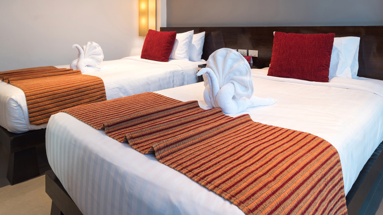 Hotel room beds with bedspreads, something you should absolutely avoid touching