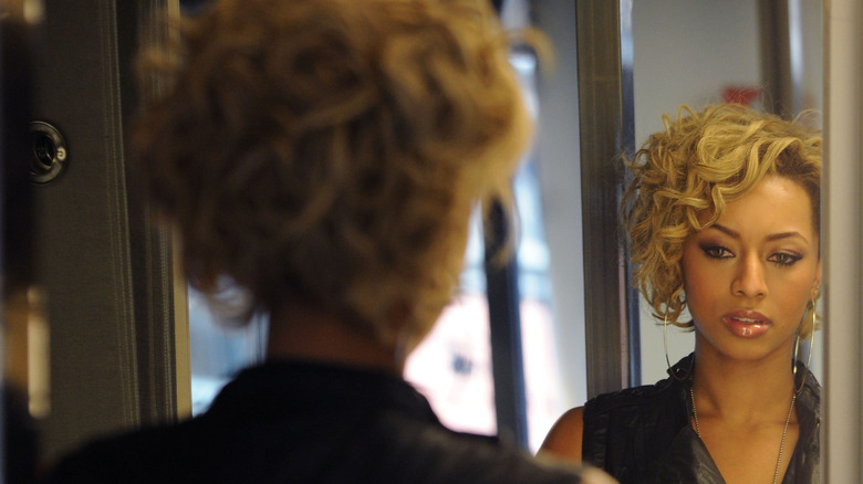 woman looking in mirror self esteem