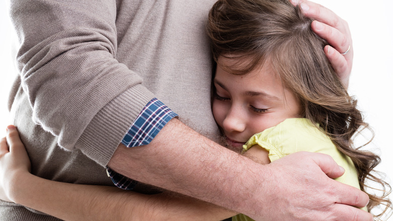 parent hugging kid