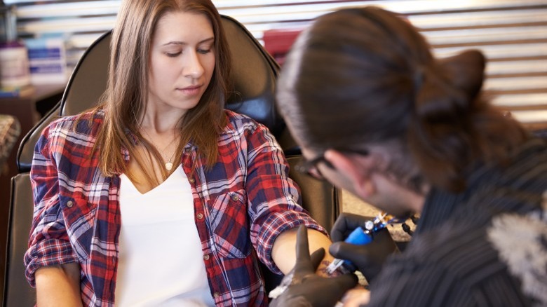 woman getting tattoo