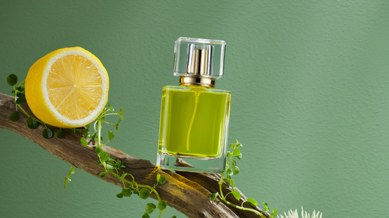 Bottle of perfume and lemon