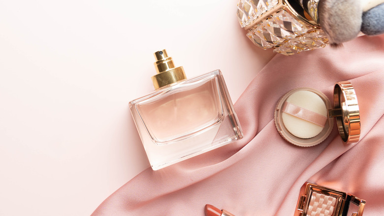 A bottle of perfume and makeup