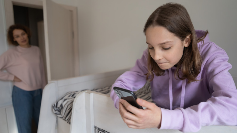 Adolescent using phone app
