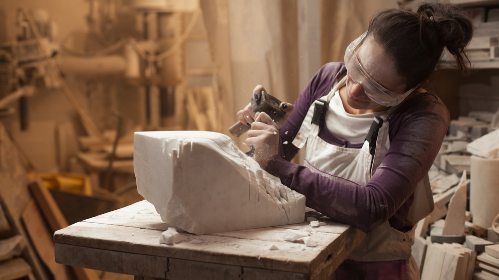 Woman sculpting in studio