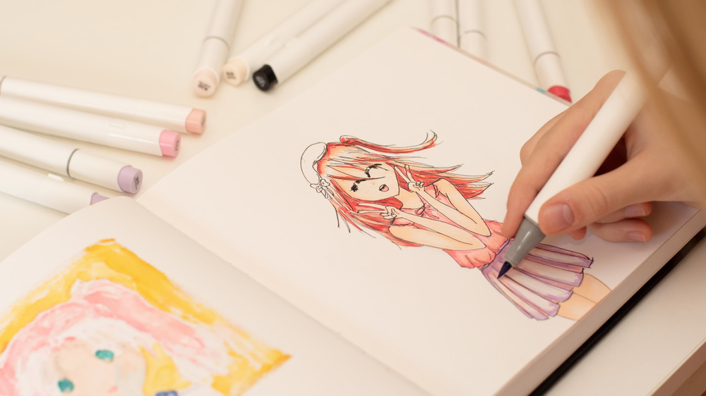 Person drawing anime girl