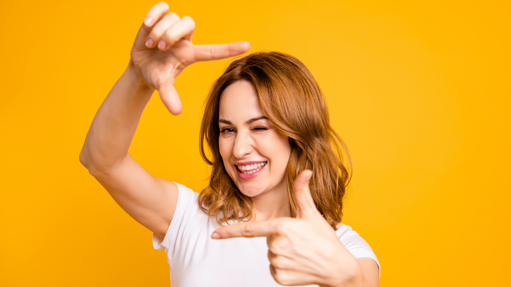 Woman using fingers to form frame