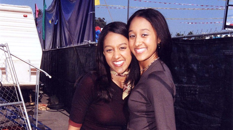 a young tia and tamera mowry smiling together