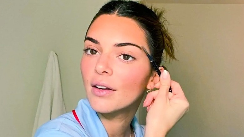 Kendall Jenner doing her makeup for Vogue's Beauty Secrets 