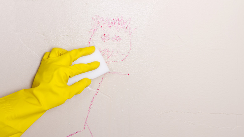 cleaning sponge removing crayon from wall