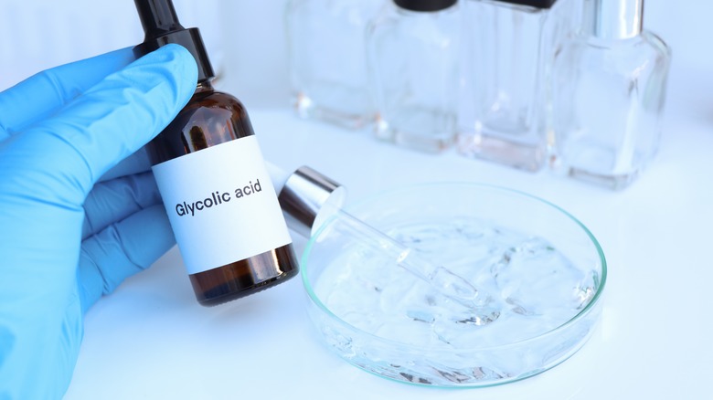 Person holding a bottle of glycolic acid