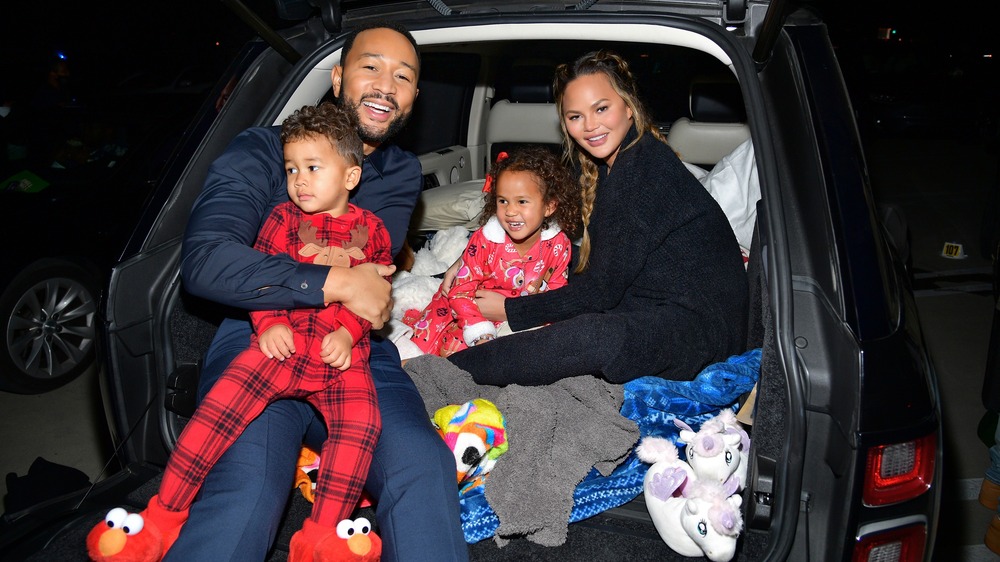 Chrissy Teigen smiling with family