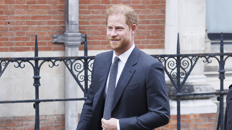 Prince Harry walking outside in suit