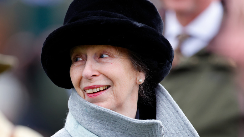 Princess Anne smiling in black hat