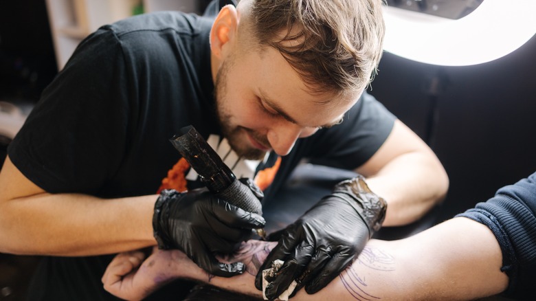 tattoo artist doing a tattoo