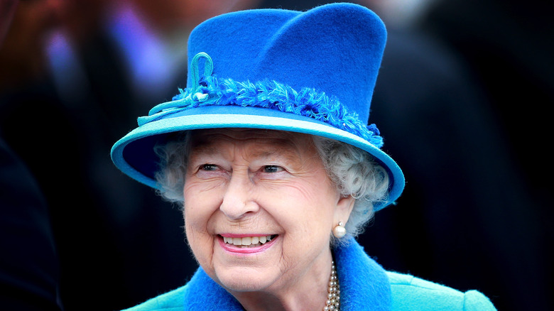 Queen Elizabeth smiling in blue