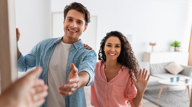 Couple welcoming a friend