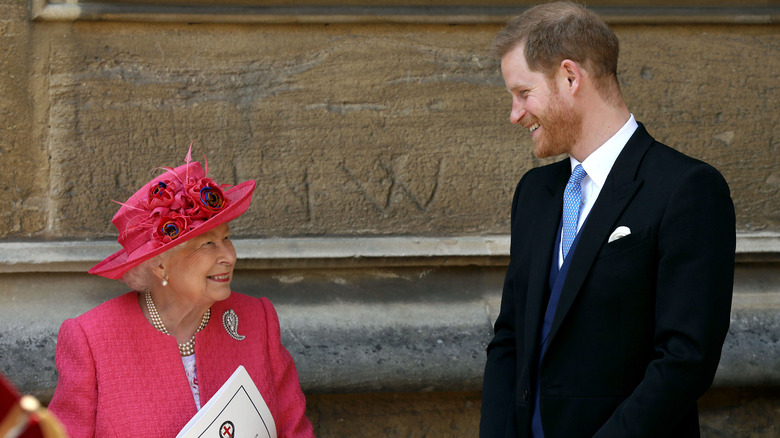 Queen Elizabeth smiling with Harry
