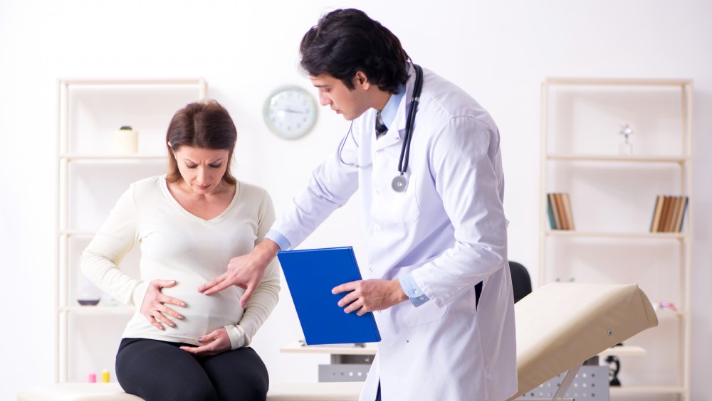 Pregnant woman with doctor