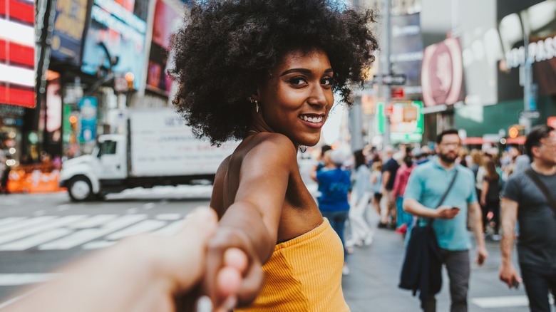 woman holding photographer's hand in Times Square