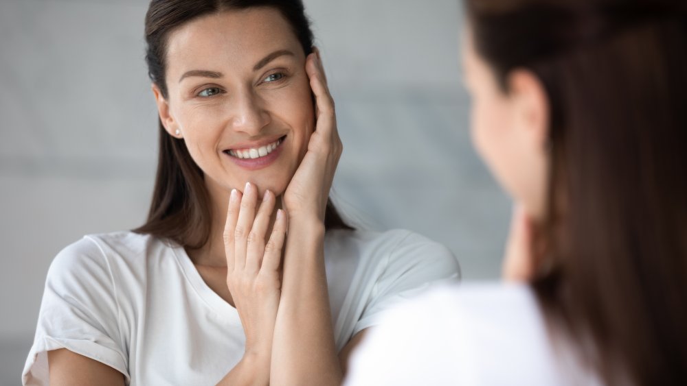 woman smiling in mirror