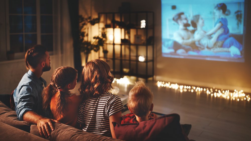 family watching a movie on a projector