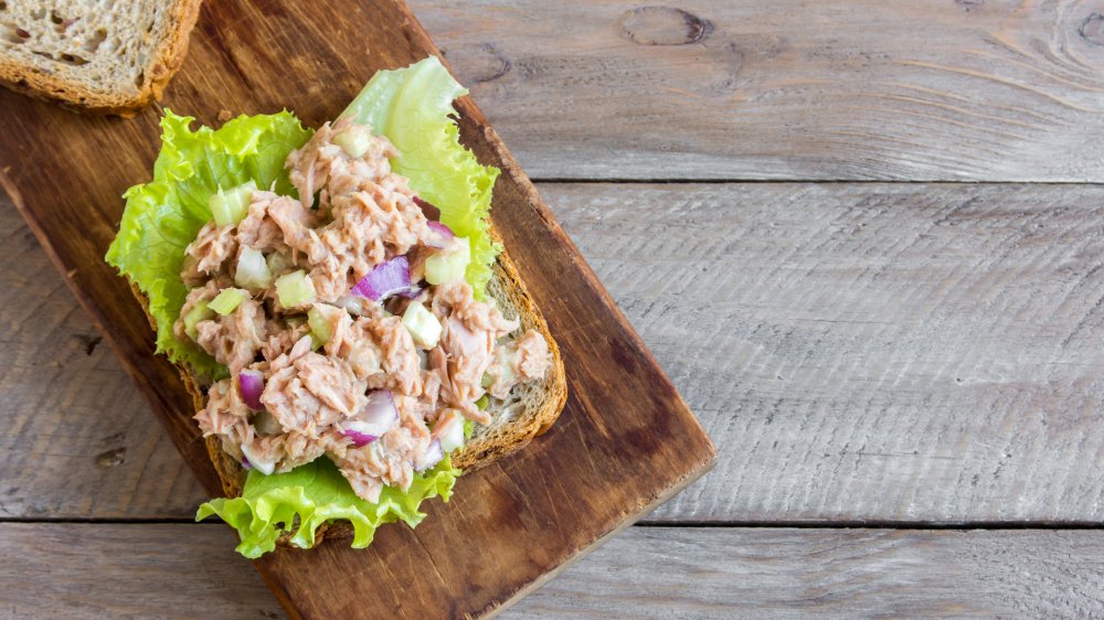 Tuna salad open faced sandwich on a board