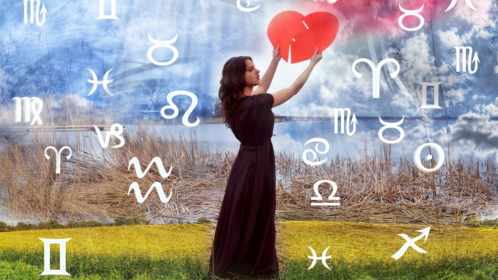 Woman hanging heart in zodiac signs