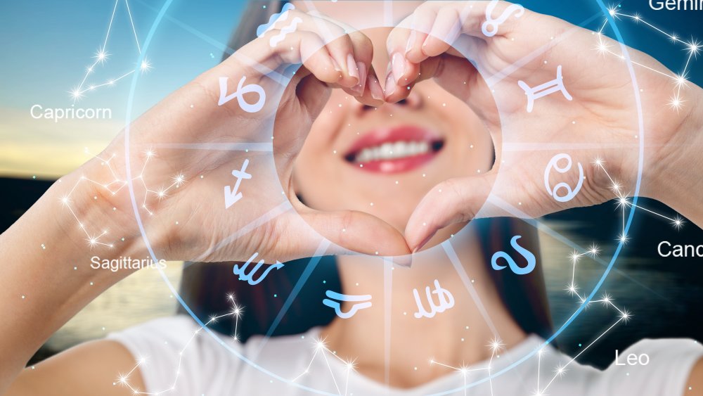 Woman doing heart hands with zodiac
