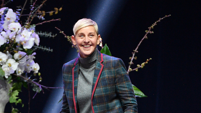 Ellen DeGeneres in front of flowers