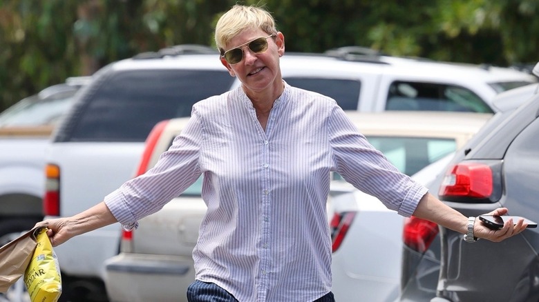 Ellen DeGeneres smiling in a parking lot