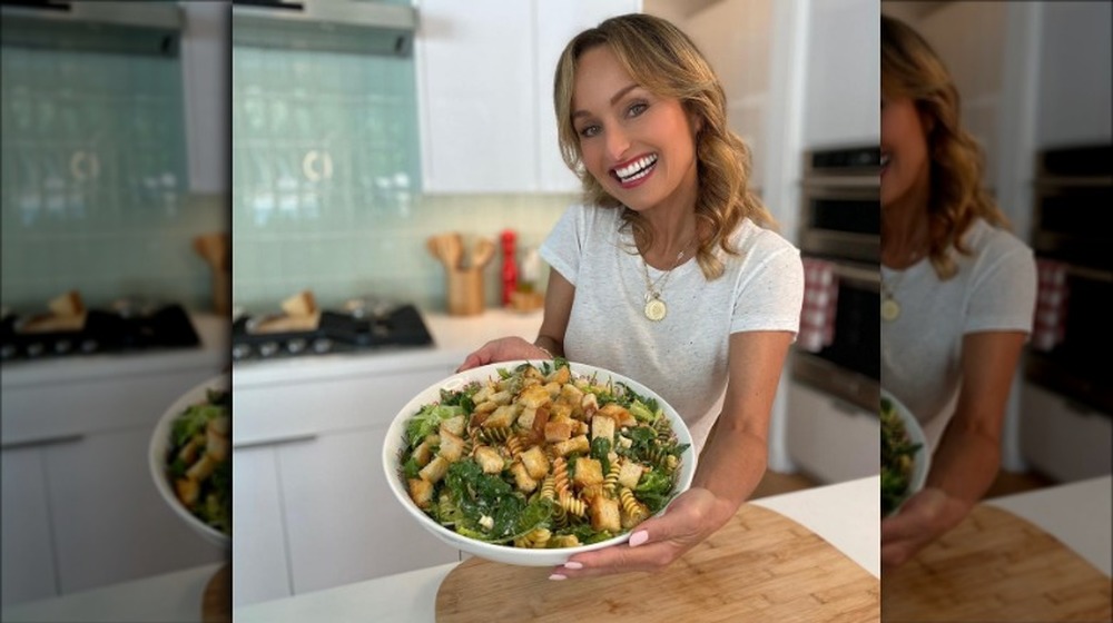 Giada De Laurentiis holding a bowl of salad with pasta