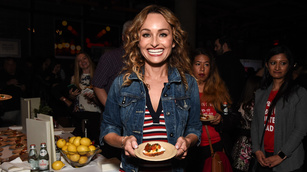 Giada De Laurentiis holding a plate with a snack on it