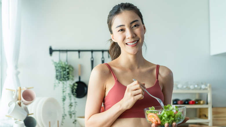 woman smiling with salad