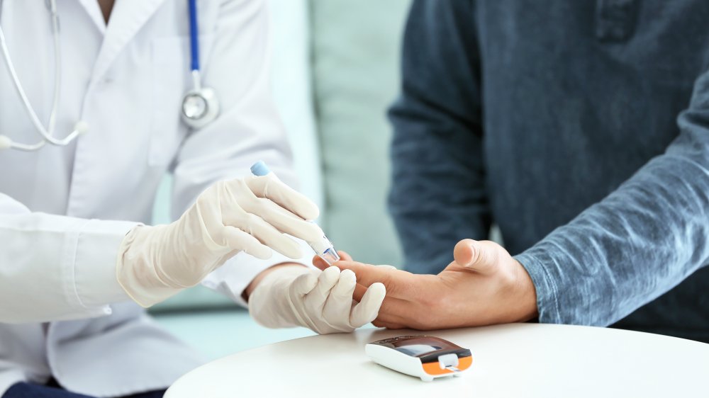 doctor testing patient for diabetes