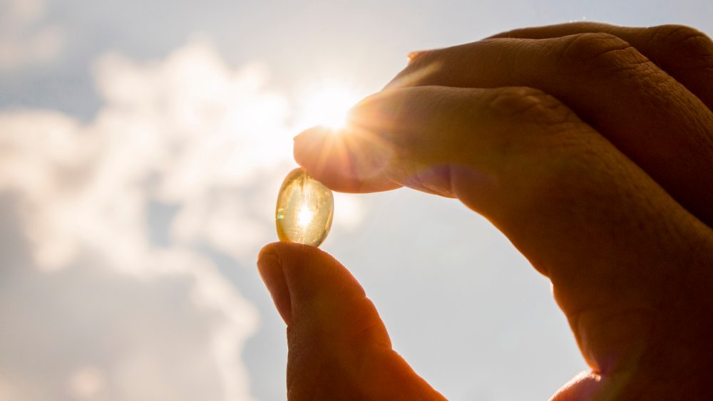 A capsule being held up to the light 