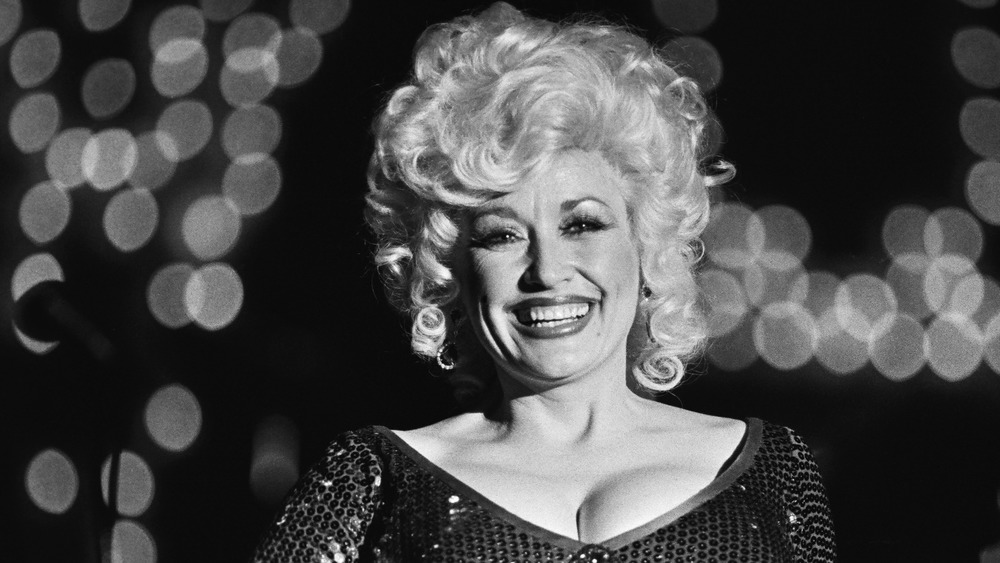 Dolly Parton smiling in a sequined dress