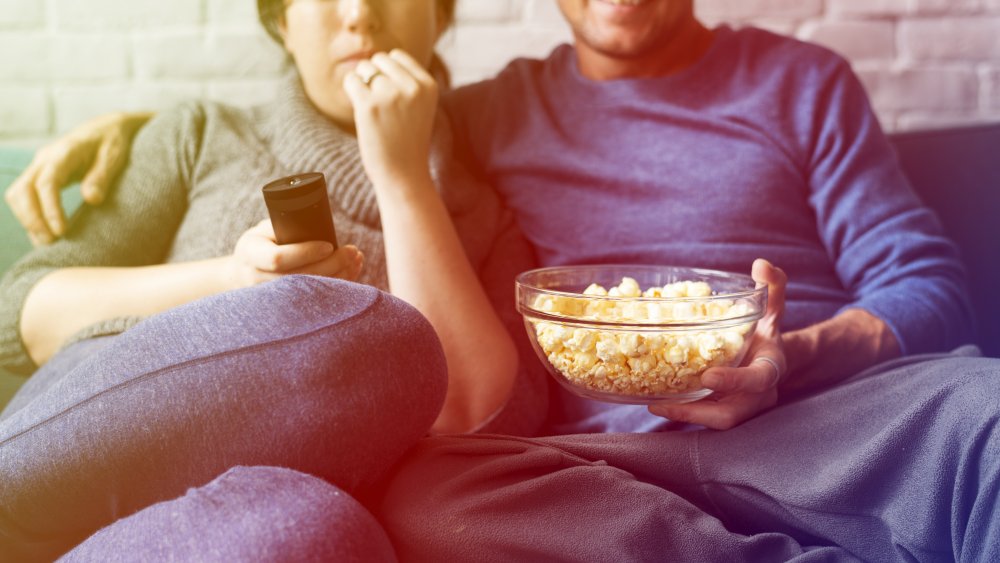 Couple watching TV with popcorn