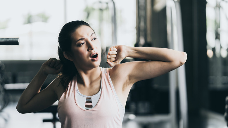 Woman yawning during workout 