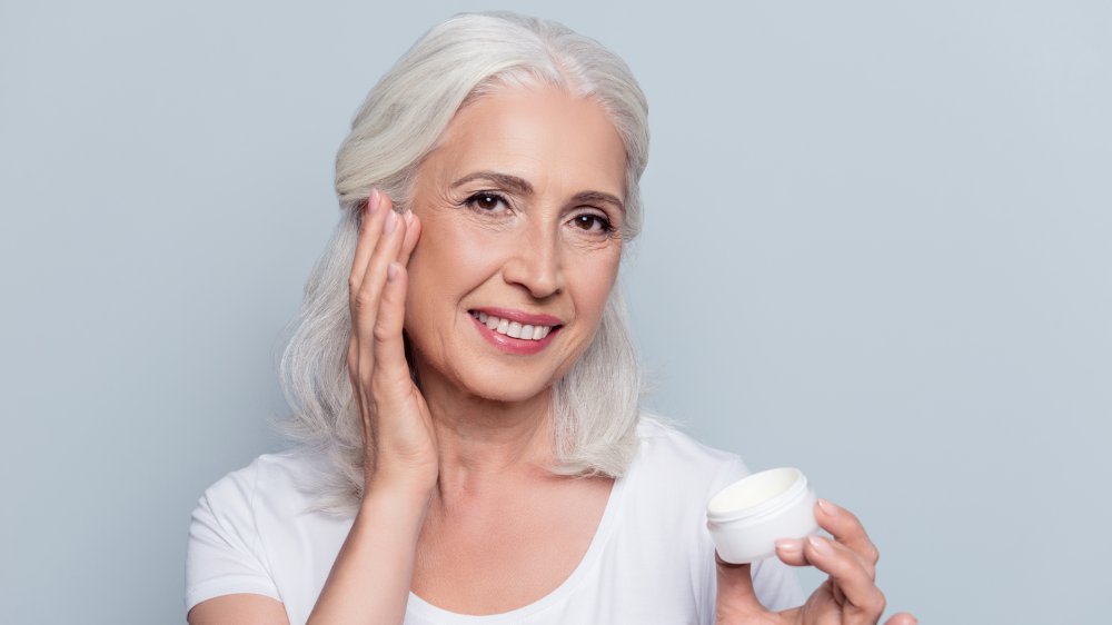 Woman applying wrinkle cream